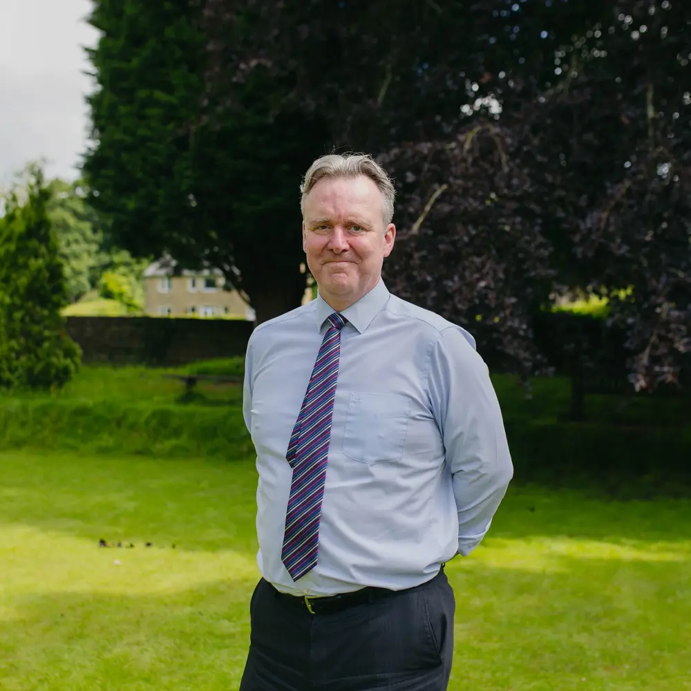 Head Teacher, Stephen Salt from Cedar House School standing in the garden wearing a shirt and tie