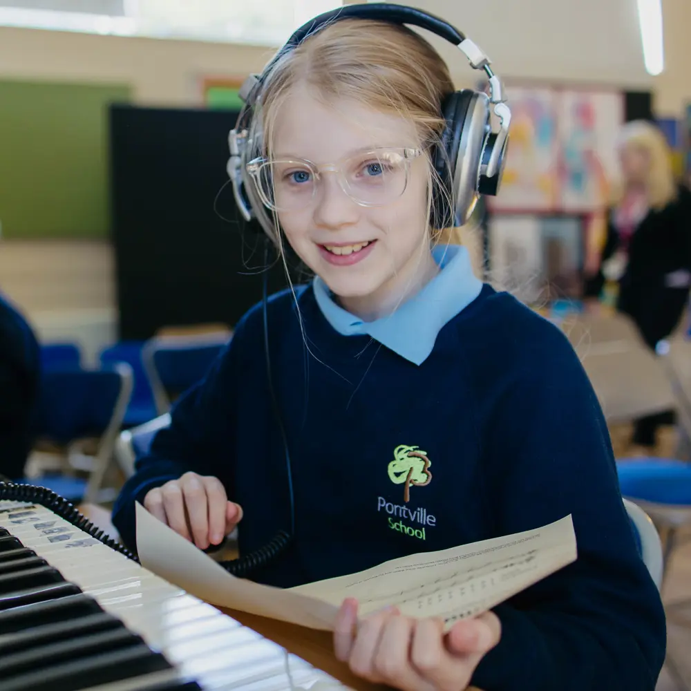 Young girl from Pontville School playing piano