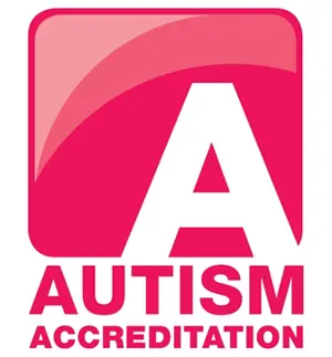 A pink square with a white A on it and Autism Accreditation written below in pink writing