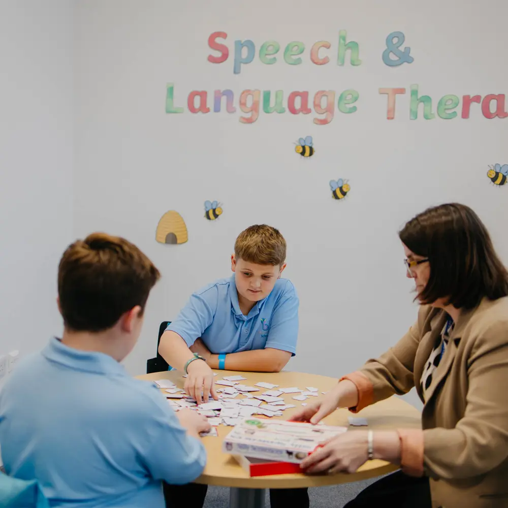 Two pupils and one member of staff for Bescot Hall School playing a game together