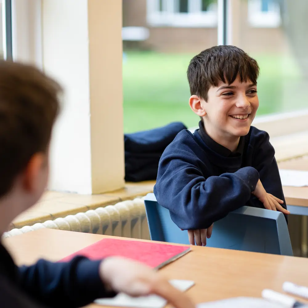 2 boys sat at their desks in a classroom at Avon Park School