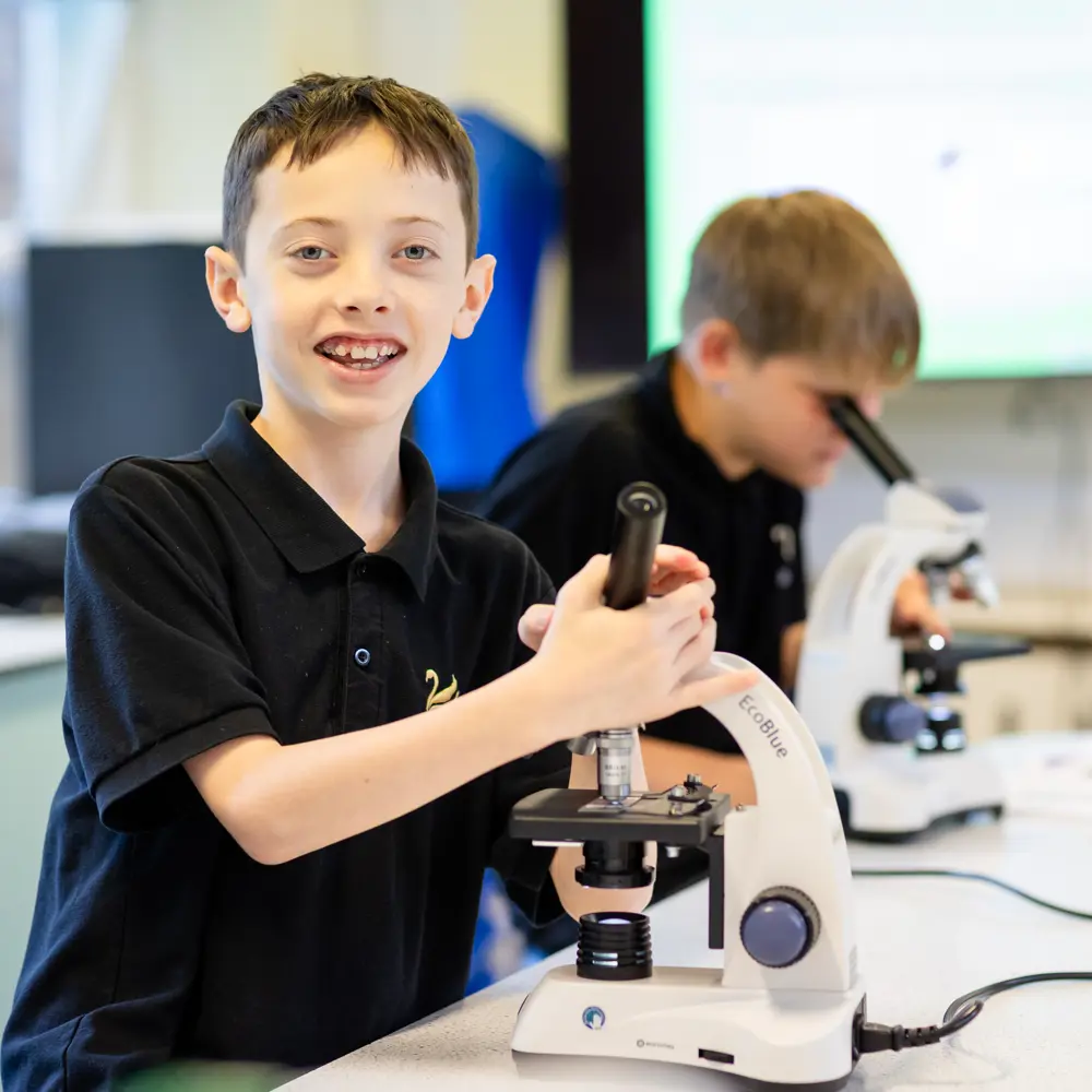 2 boys with microscopes in the lab at Avon Park School