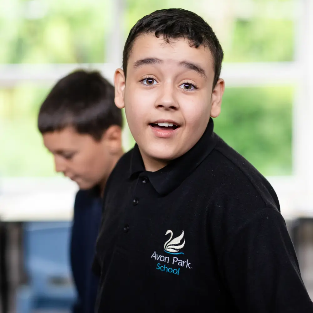 2 boys at Avon Park School, one smiling at the camera
