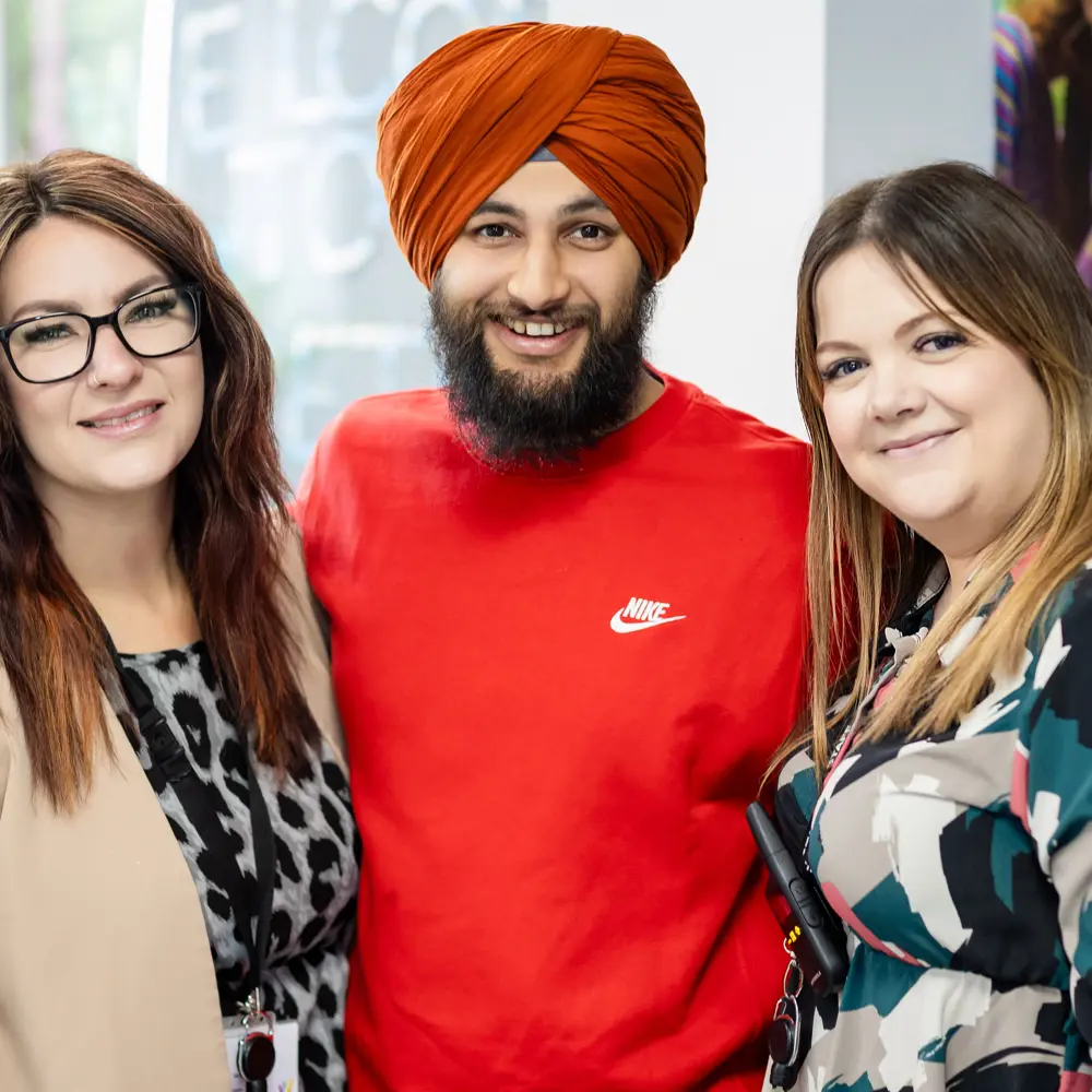 One male and two female members of staff from Dovetree School smiling into camera