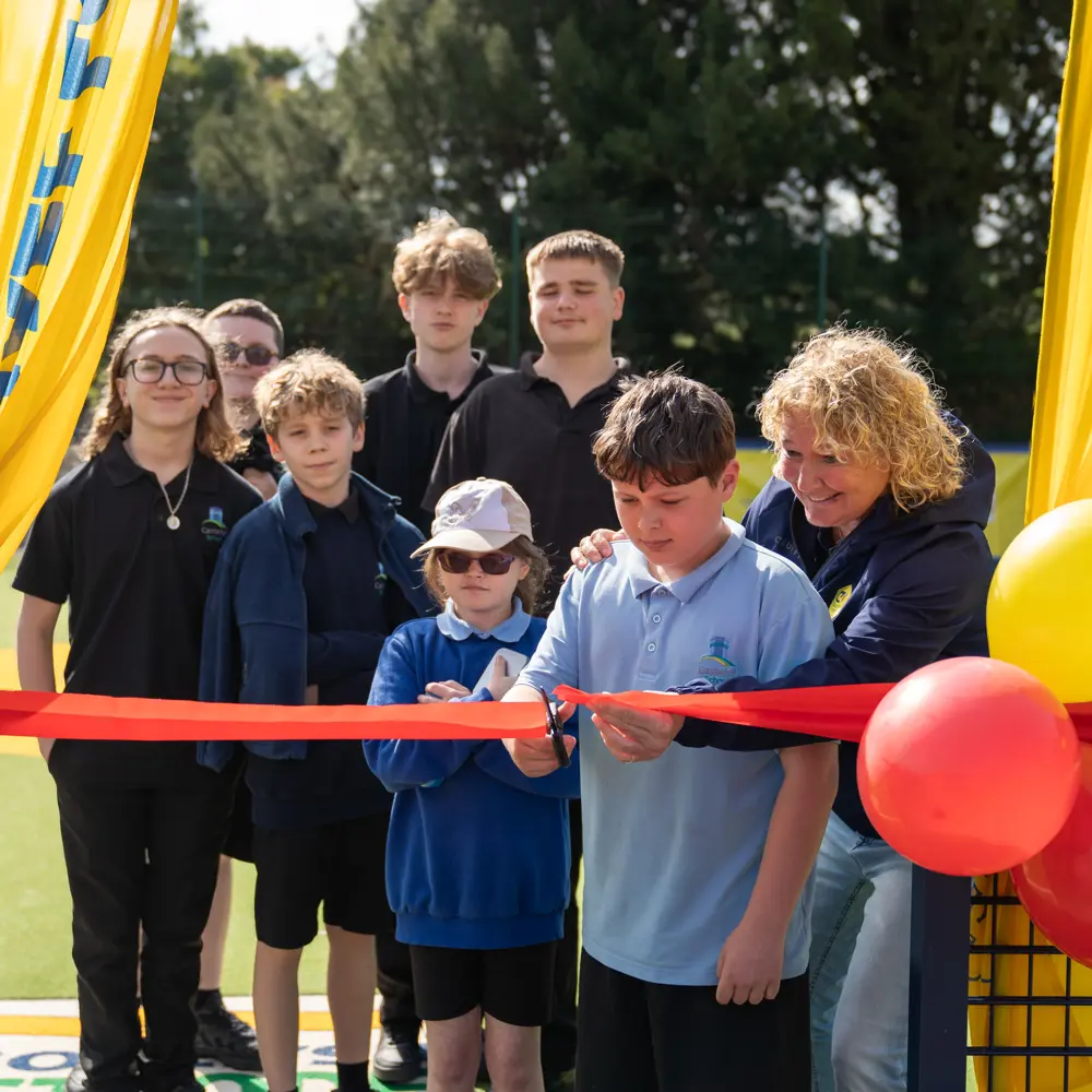 Castlefell School Cruyff Court opening of pupils cutting a red ribbon