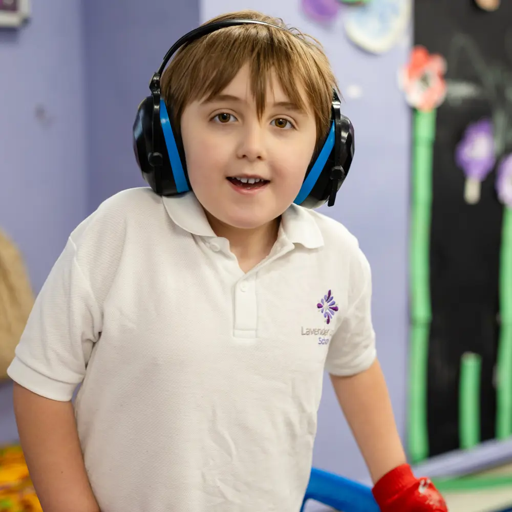 Smiling brown-haired boy wearing headphones
